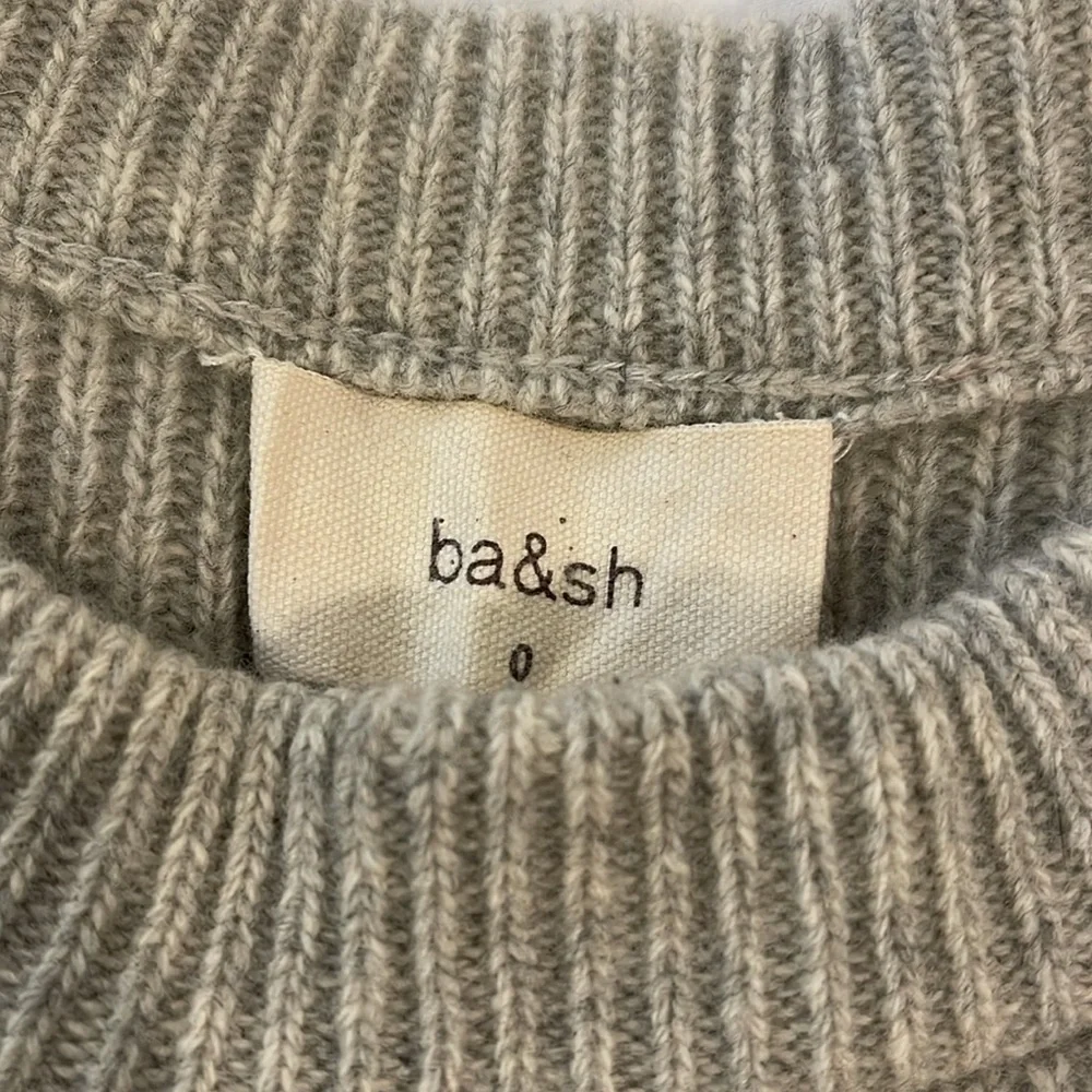 Gray crewneck sweater with lace up detail
